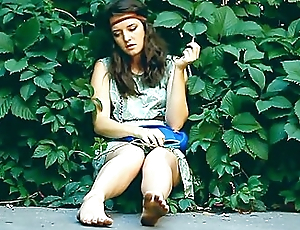 Adorable Brunette Hippy Gal Sits In Shrubs And Her Obscene Feet While Smoking