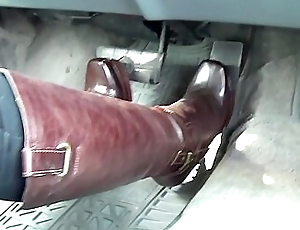 Watch This Sexy Woman In Tight-red Leather Boots Push Concerning The Auto Pedals