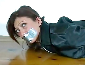 Girl In Leather Hogtied Together with Tape-gagged