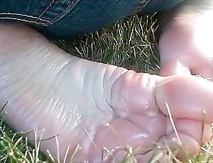 Redhead Teen Is With Her Knees On The Grass Exposing Her Perfect Oily Feet